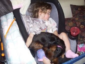 Precious moment during our travel time.  Olivia with our dog - Snuggles.  She sure is "snuggly".............smile.