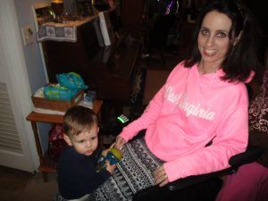 When Amy is up and about in her wheelchair, Garrett enjoys bonding time with his Mama by getting up on her foot-rests and going along for the ride!