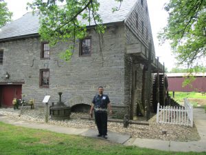 David standing in front of the building/mill.